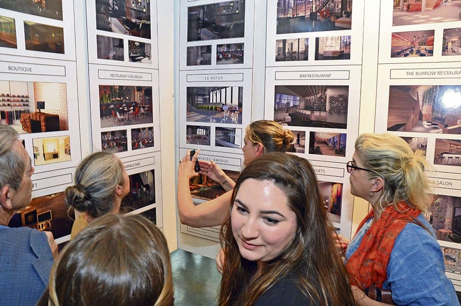 Inter-Dec College interior design students admire photos of some of their work