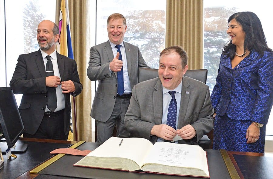 Greek Consul General in Montreal Nicolaos Sigalas signs the Golden Book at Laval city hall on March 25.